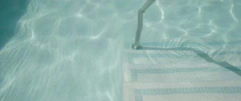 Tilting up turquoise summer pool in slow motion Stock Footage 136447794