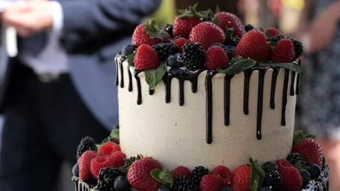 Tilting upwards over a beautiful multi-tier wedding cake with fresh berries. Stock Footage 195121308