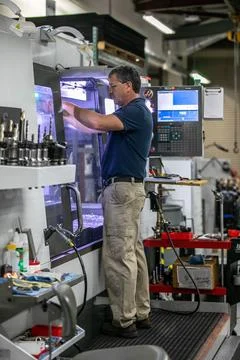 Tim Evans, a mechanical engineering technician, uses a computer numerical c.. Stock Photos