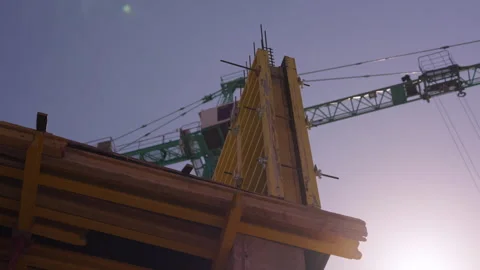 Timber formwork panels and tower crane at concrete construction site Stock Footage 346551034