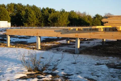 Timber frame base on piles, early construction stage, structural setup, woo.. Photos