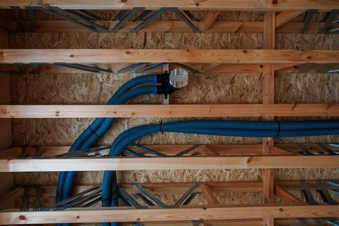 Timber frame ceiling cavity with ducts, I joists, and OSB sheathing Stock Photos