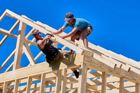 Timber frame comprises interconnected truss elements. One construction work.. Stock Photos