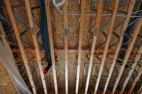 Timber frame house ceiling services with engineered joists and MEP Stock Photos
