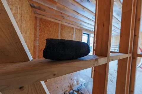 Timber frame house interior during build with Bluetooth speaker on stud Stock Photos