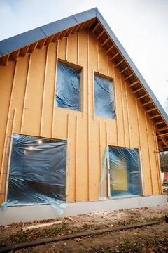 Timber frame house under construction with insulated sheathing Stock Photos