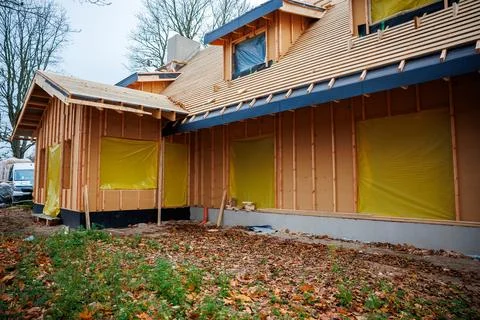 Timber framed house under construction with multi gable roof Stock Photos
