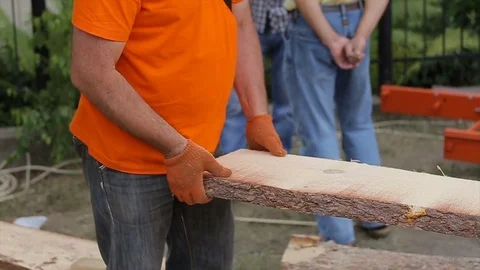 Timber mill. View of sawing wood with sawmill machine. Carpenter loads boards Stock Footage 75407638
