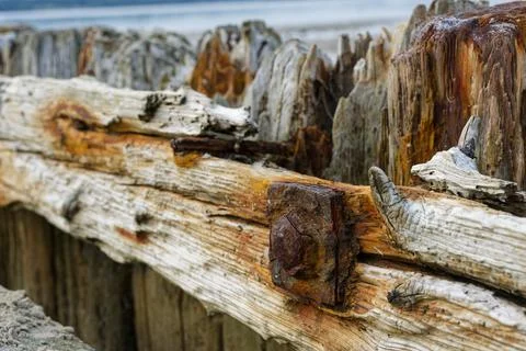 Timber posts joined by a beam with a large rusted split nail at Solituede F.. Stock Photos
