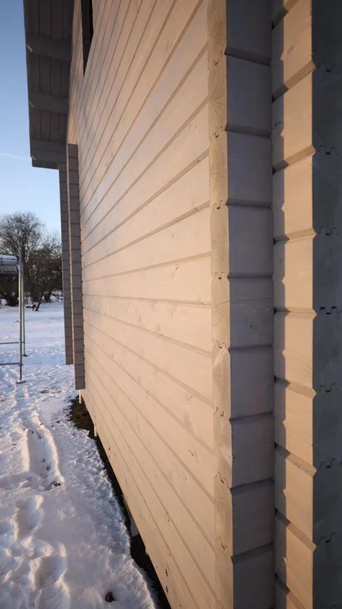 Timber wall at sunset, interlocking log corner and plank cladding Stock Footage 327941429