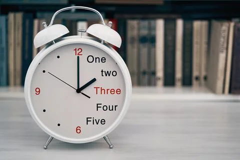 Time 2 two or 14 fourteen hours on a desk clock Stock Photos