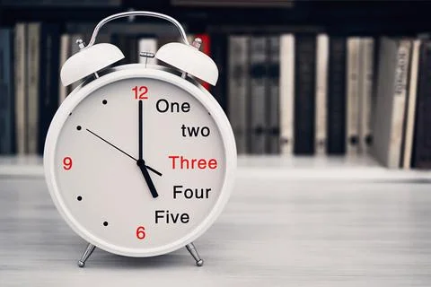 Time 5 five or 17 seventeen hours on a desk clock Stock Photos