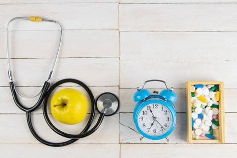Time to accept tablets. Phonendoscope and tablets in a wooden box along with  Stock Photos