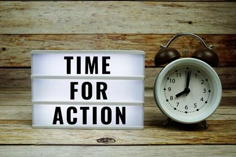 Time for Action text on LED lightbox with alarm clock on wooden background Stock Photos