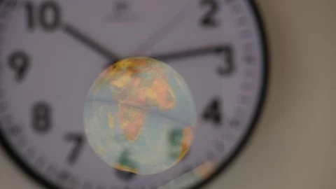 Time and space, a globe reflected on a wall clock. Video stock 122316633