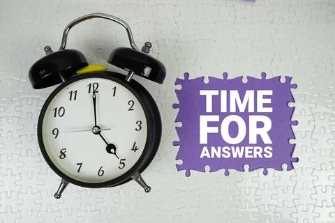 Time For Answers text with alarm clock on purple background Stock Photos