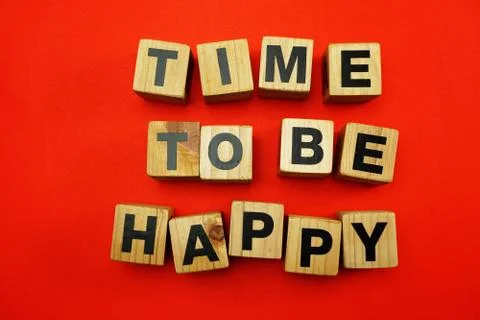 Time To Be Happy created with cubes alphabet letters on red background Stock Photos