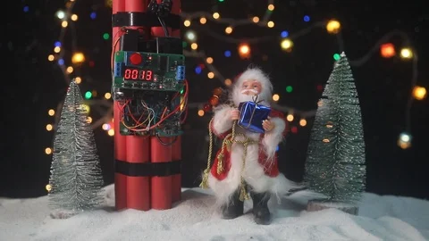 Time bomb (dynamite) on snow with holiday decor and santa Stock Footage 121730558