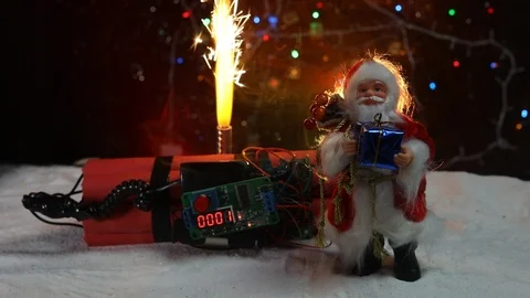 Time bomb (dynamite) on snow with holiday decor and santa Stock Footage 121730619