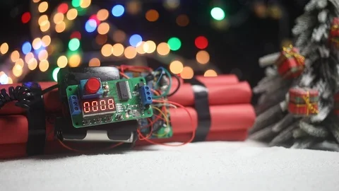 Time bomb (dynamite) on snow with holiday decor and santa Stock Footage 121730688