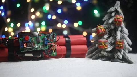 Time bomb (dynamite) on snow with holiday decor and santa Stock Footage 121730697