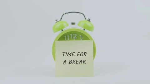 Time for a break word on sticky note in front of green clock and ringing Stock Footage 313913794