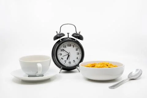 Time for breakfast concept with clock, cereal and coffee Stock Photos