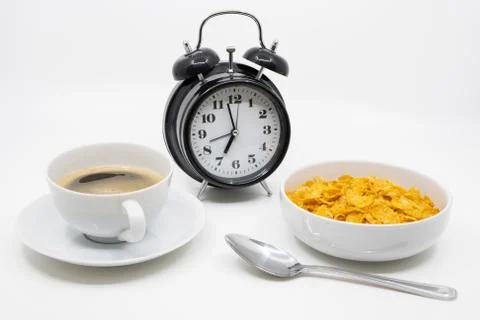 Time for breakfast concept with clock, cereal and coffee Stock Photos