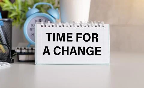 TIME TO CHANGE word written on notepad. TIME TO CHANGE text on table, concept Stock Photos