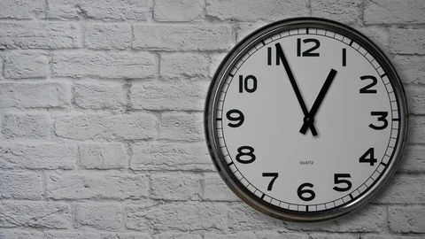 The Time On The Clock One. Clock With The Black Arrows With The Arabic Numerals  Vídeo Stock 128855180