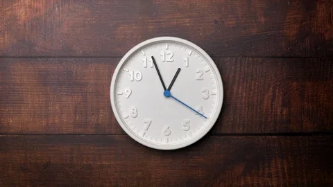 The Time On The Clock One. White Clock With The Blue Arrow With The Arabic Numer Stock Footage 128741646