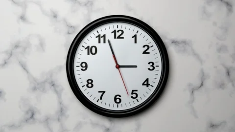 The Time On The Clock Three. Black Clock With The Red Arrow With The Arabic Nume Stock Footage 128741067