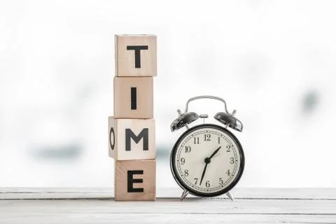 Time concept with a clock and a word Stock Photos