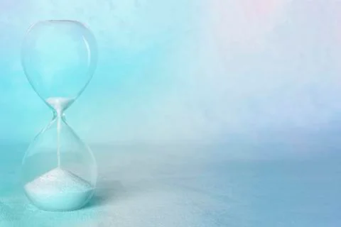 Time concept. An hourglass with the period coming to an end, with copy space, in Stock Photos