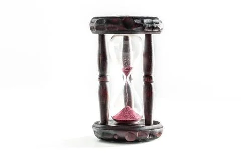 Time concept. An hourglass with sand falling through, on a white background Foto stock