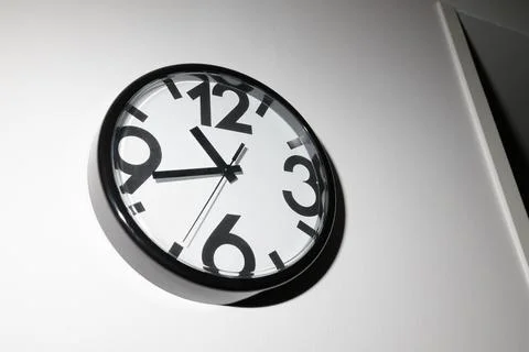 Time concept with watch or clock on white wall Stock Photos