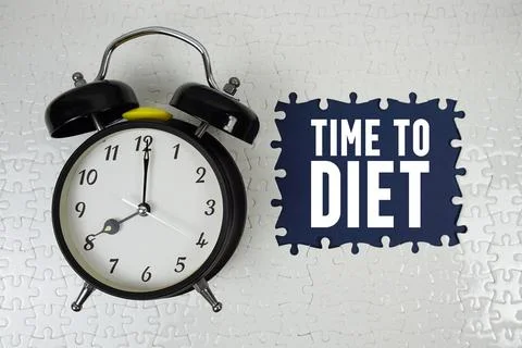 Time To Diet text with alarm clock on navy blue background Stock Photos