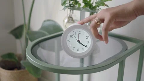 Time displayed on a clock in a simple home decor setting Stock Footage 339258213