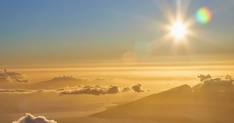 Time Elapse of setting sun above moving clouds at Haleakala Crater Summit Stock Footage 114935283