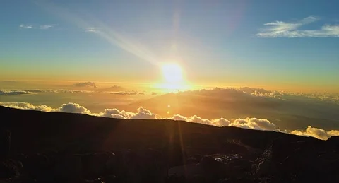 Time Elapse of setting sun above moving clouds at top of Haleakala Crater Summit Stock Footage 114952369