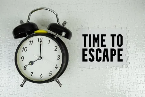 Time to Escape text with alarm clock on white background Stock Photos