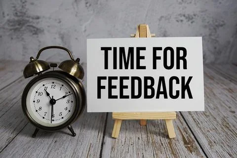 Time for Feedback text message and alarm clock on wooden background Stock Photos