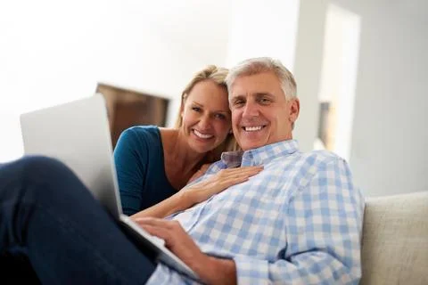 Time to get comfy and connect. Portrait of a mature couple using a laptop Fotos Stock