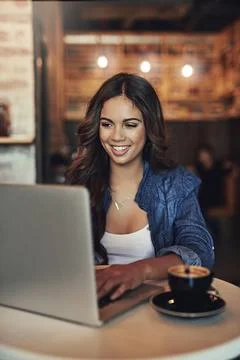 Time to get those creative juices flowing. a relaxed young woman using her Stock Photos
