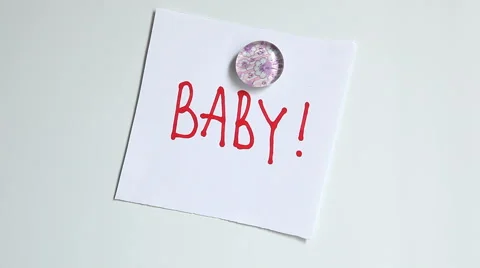 Time to give birth- hands changing word pregnant to baby Stock Footage 65313841