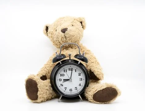 Time to go to bed concept with clock and teddy bear Stock Photos