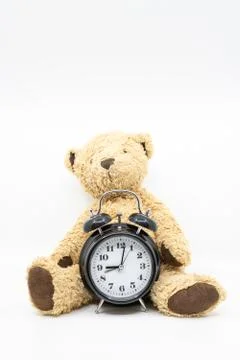 Time to go to bed concept with clock and teddy bear Stock Photos