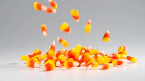 Time for Halloween. Delicious candy corn falls in slow motion. Stock Footage