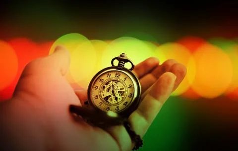 The time on hand with bokeh background Stock Photos
