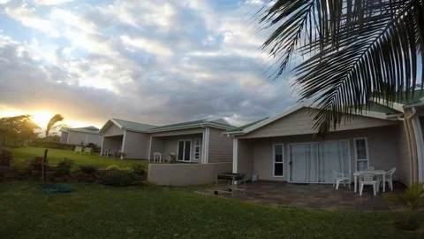 Time Iapse sunset on a background of palm trees and houses in Africa Stock Footage 71405028